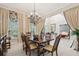 Formal dining room featuring decorative chandelier, elegant furnishings and abundant natural light at 3201 Glenmere Way, Orlando, FL 32828