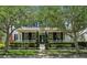 Charming two-story home with mature trees, a cozy front porch, and manicured landscaping at 3201 Glenmere Way, Orlando, FL 32828