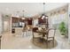 Bright kitchen featuring breakfast bar, stainless steel appliances, and adjacent dining area at 3201 Glenmere Way, Orlando, FL 32828