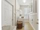 Bright laundry room featuring tile flooring, storage cabinets, washer and dryer hookups, and natural light from a window at 3201 Glenmere Way, Orlando, FL 32828
