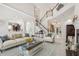 Bright and airy living room with high ceilings, elegant staircase, and hardwood floors at 3201 Glenmere Way, Orlando, FL 32828
