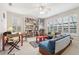 Inviting living room with built-in bookshelves, two sofas, ceiling fan and natural light from multiple windows at 3201 Glenmere Way, Orlando, FL 32828