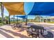 Community picnic area with tables and sunshades surrounded by lush landscaping at 3201 Glenmere Way, Orlando, FL 32828