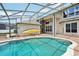 Backyard with screened-in pool area, yellow kayak, and view of the home's architecture at 3201 Glenmere Way, Orlando, FL 32828
