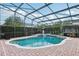 Inviting screened-in pool area with brick patio, lush landscaping, and plenty of space for outdoor enjoyment at 3201 Glenmere Way, Orlando, FL 32828