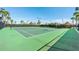Well-maintained community tennis courts surrounded by palm trees and lush greenery at 3201 Glenmere Way, Orlando, FL 32828