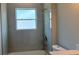 Bathroom featuring a shower and tub combination, and a toilet near a window at 3498 Sw 131St Place Rd, Ocala, FL 34473