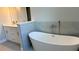 Contemporary bathroom with a stand-alone tub, modern fixtures, and elegant tile work at 3498 Sw 131St Place Rd, Ocala, FL 34473