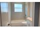Bright bathroom with tub and shower combination, a window, and a vanity with countertop sink at 3498 Sw 131St Place Rd, Ocala, FL 34473