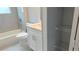 Bathroom featuring a tub and shower combination, toilet, vanity, and open shelving at 3498 Sw 131St Place Rd, Ocala, FL 34473