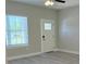 Bright bedroom with a modern ceiling fan, window with blinds, and a door to the yard at 3498 Sw 131St Place Rd, Ocala, FL 34473