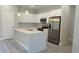 Modern kitchen features a central island, stainless steel appliances, and pendant lighting at 3498 Sw 131St Place Rd, Ocala, FL 34473