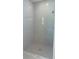 A sleek, modern bathroom featuring a spacious walk-in shower with light gray tiling and a marble base at 3498 Sw 131St Place Rd, Ocala, FL 34473