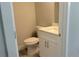 Clean and modern powder room featuring a white vanity with countertop sink and a toilet at 3498 Sw 131St Place Rd, Ocala, FL 34473