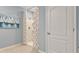 Bright bathroom featuring walk-in shower with tiled surround, decorative curtain, and neutral color scheme at 3507 Costello Cir, Winter Haven, FL 33884