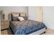 Comfortable bedroom with a large bed, stylish side table and lamp, and a door to the bathroom at 3507 Costello Cir, Winter Haven, FL 33884