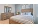 Beautiful bedroom with wood furniture, striped bedding, coordinated wall art, and neutral carpet at 3507 Costello Cir, Winter Haven, FL 33884