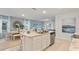 Open kitchen featuring a center island with sink and stainless steel appliances overlooking the living room at 3507 Costello Cir, Winter Haven, FL 33884
