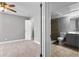 Spacious bedroom leading to a bathroom with modern fixtures, gray walls and neutral carpeting at 380 Lake Ontario Ct # 201, Altamonte Springs, FL 32701