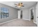 A cozy bedroom featuring carpet, a window, and a glimpse into the closet and bathroom at 380 Lake Ontario Ct # 201, Altamonte Springs, FL 32701