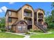 The exterior of the condo complex is inviting, featuring a well-maintained lawn and an exterior staircase at 380 Lake Ontario Ct # 201, Altamonte Springs, FL 32701