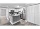A well-lit kitchen featuring modern appliances, gray countertops and flooring, and ample cabinet space at 380 Lake Ontario Ct # 201, Altamonte Springs, FL 32701