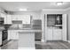 Modern kitchen with white cabinets, stainless steel appliances, and a center island with granite countertops at 380 Lake Ontario Ct # 201, Altamonte Springs, FL 32701