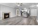 Spacious living room is open to kitchen and features fireplace, ceiling fan, and wood-look flooring at 380 Lake Ontario Ct # 201, Altamonte Springs, FL 32701