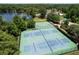 Aerial view of tennis courts and basketball courts within a lakefront community at 383 Remington Dr, Oviedo, FL 32765