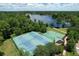 Overhead shot of tennis and basketball courts near a lake in a picturesque setting at 383 Remington Dr, Oviedo, FL 32765