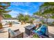 Beautiful backyard with a fire pit, built-in grill, mature landscaping, and refreshing in-ground pool at 383 Remington Dr, Oviedo, FL 32765