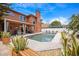 Beautiful backyard featuring a pool, an outdoor kitchen, a covered patio, and lush landscaping at 383 Remington Dr, Oviedo, FL 32765