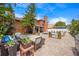 Landscaped backyard with a pool, a fire pit, a built in kitchen, and ample lounge seating at 383 Remington Dr, Oviedo, FL 32765