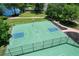 Aerial view of a basketball court surrounded by lush trees and manicured lawns at 383 Remington Dr, Oviedo, FL 32765