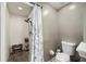 This bathroom features a tiled shower with river rock floor and a floral shower curtain at 383 Remington Dr, Oviedo, FL 32765