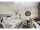 Comfortable bedroom with ceiling fan, light walls, and a cozy, floral-patterned bedspread at 383 Remington Dr, Oviedo, FL 32765