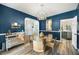 Dining room features blue walls, wood floors, and a glass table with seating for four at 383 Remington Dr, Oviedo, FL 32765