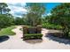 Remington Park entrance sign with brick pillars, lush landscaping and meandering walkways at 383 Remington Dr, Oviedo, FL 32765