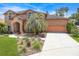 Charming two-story brick home featuring a well-manicured front yard and a driveway at 383 Remington Dr, Oviedo, FL 32765