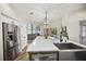 This kitchen is complete with stainless appliances, oversized island, and backyard access at 383 Remington Dr, Oviedo, FL 32765