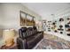 Inviting living room featuring a comfortable leather sofa and custom built-in shelving unit at 383 Remington Dr, Oviedo, FL 32765