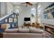 Open living area with tall windows, stylish furnishings and a cozy fireplace at 383 Remington Dr, Oviedo, FL 32765