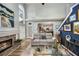 Inviting living room with a fireplace, backyard access, and a view into the kitchen at 383 Remington Dr, Oviedo, FL 32765