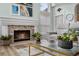Stone fireplace and modern decor enhance the ambiance of this comfortable living room at 383 Remington Dr, Oviedo, FL 32765