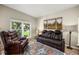 Comfortable living room featuring a leather recliner, sofa, and a bright window with outside views at 383 Remington Dr, Oviedo, FL 32765