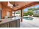 Outdoor living space featuring a bar top, ceiling fan, and a view of the pool at 383 Remington Dr, Oviedo, FL 32765
