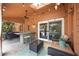 Inviting covered patio with a bar, ceiling fan, skylight, and sliding glass doors to the interior at 383 Remington Dr, Oviedo, FL 32765