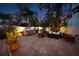 Cozy outdoor patio area with a built-in grill, comfortable seating, and beautiful brick pavers at 383 Remington Dr, Oviedo, FL 32765