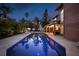 Stunning backyard pool reflecting the lights of the home and mature landscaping at 383 Remington Dr, Oviedo, FL 32765