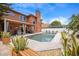 Backyard pool with an entertainment area, covered patio, and beautiful landscaping on a sunny day at 383 Remington Dr, Oviedo, FL 32765